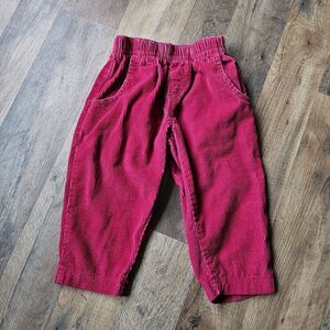 Vintage 80's and 90's OshKosh corduroy red pants with leather label on the back.